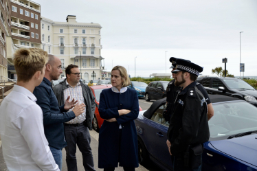 Amber is pictured with representatives from Sussex Police talking to local business owners affected by anti-social behaviour